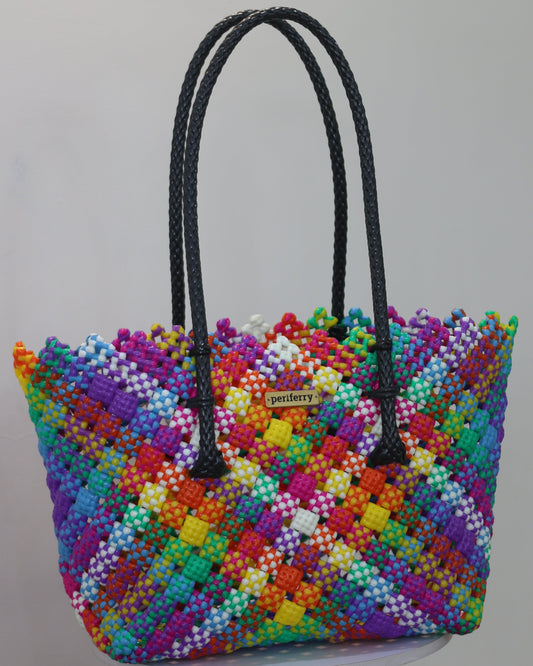 Colorful knitted handbag with a black braided handle on a white background