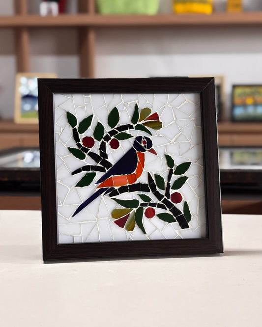 Framed mosaic artwork of a bird on a branch with leaves and berries.